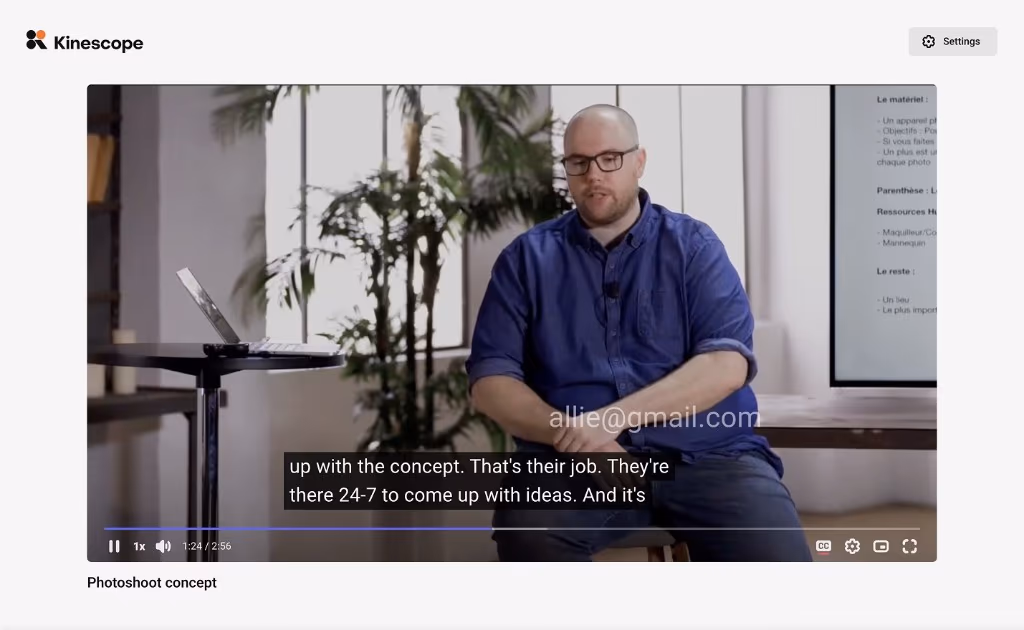 A video playing with a viewer's email shown as a watermark