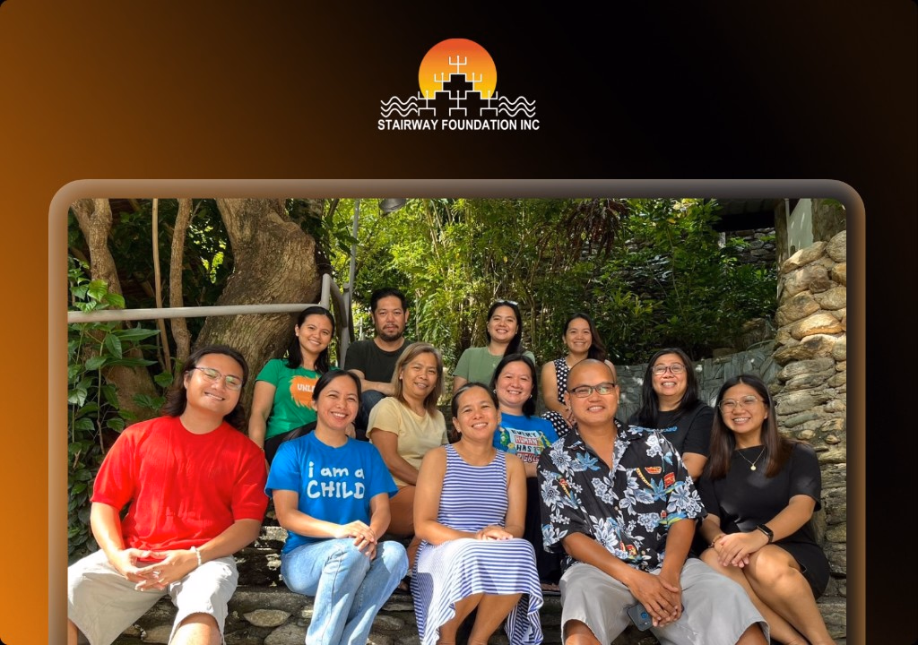 Stairway Foundation team outdoors under the foundation logo — child-protection nonprofit case study.
